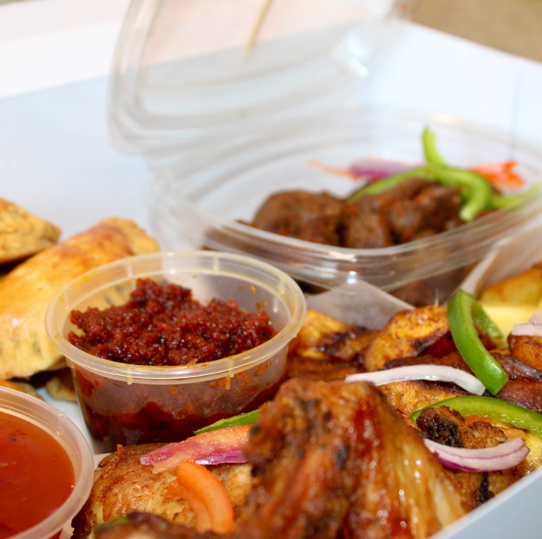 Heavenly Cuisine UK catering platter with grilled chicken, plantain, pastries and dipping sauces